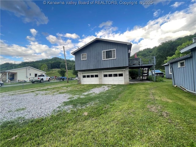 7966 Deepwater Mountain Rd, Kincaid, WV 25119 - view of side of property featuring stairs, an attached garage, driveway, a wooden deck, and a lawn