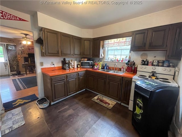 7966 Deepwater Mountain Rd, Kincaid, WV 25119 - kitchen with a sink, stainless steel microwave, light countertops, ceiling fan, and dark brown cabinetry