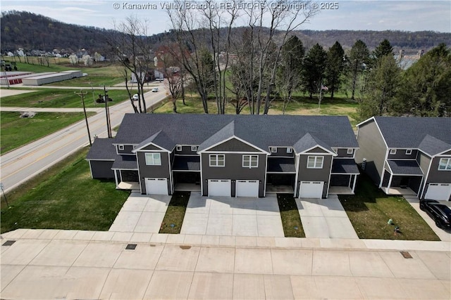 25 Jordon Dr, Winfield, WV 25213 - view of front of house featuring an attached garage, driveway, a mountain view, and stucco siding