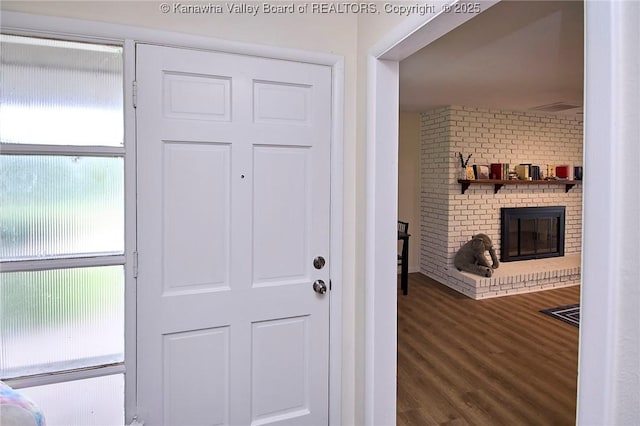 5201 Hammons Dr, Charleston, WV 25313 - entrance foyer featuring wood finished floors and a brick fireplace
