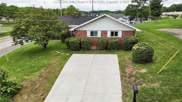 5201 Hammons Dr, Charleston, WV 25313 - view of front facade with brick siding, a front yard, and a chimney