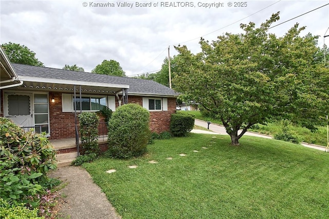 5201 Hammons Dr, Charleston, WV 25313 - view of front of home featuring brick siding, a front yard, roof with shingles, and a porch