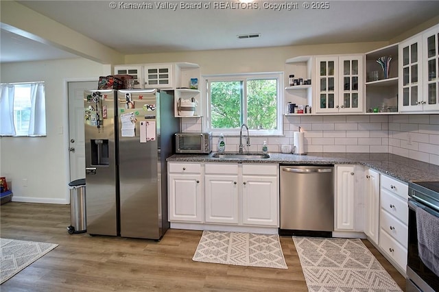 5201 Hammons Dr, Charleston, WV 25313 - kitchen with open shelves, stainless steel appliances, a sink, white cabinets, and light wood finished floors