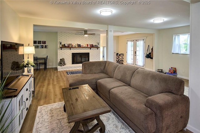 5201 Hammons Dr, Charleston, WV 25313 - living room with a fireplace, light wood finished floors, ceiling fan, and baseboards