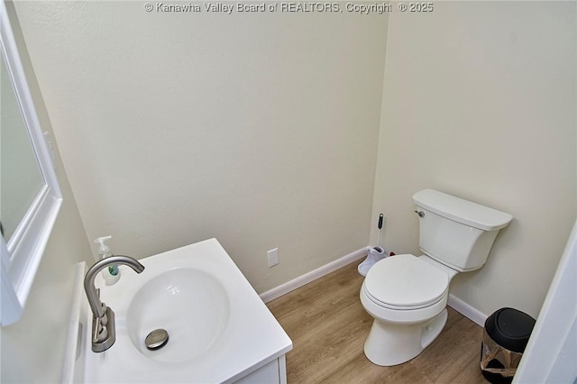 5201 Hammons Dr, Charleston, WV 25313 - bathroom featuring wood finished floors, toilet, vanity, and baseboards