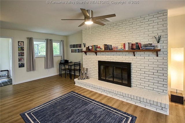 5201 Hammons Dr, Charleston, WV 25313 - living room featuring a ceiling fan, wood finished floors, a brick fireplace, and baseboards