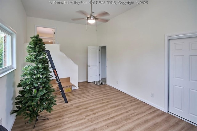 5201 Hammons Dr, Charleston, WV 25313 - spare room with wood finished floors, ceiling fan, baseboards, and a towering ceiling