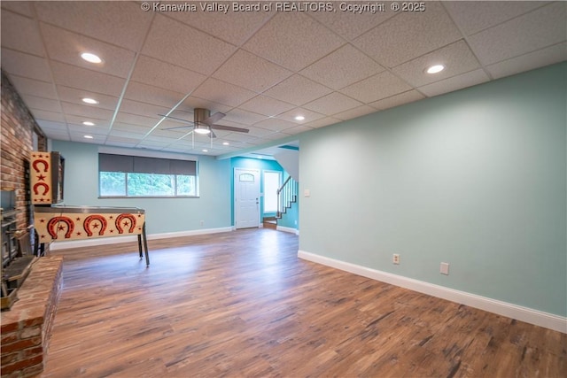102 Utah Hollow Rd, Charleston, WV 25312 - unfurnished living room featuring wood finished floors, baseboards, stairway, ceiling fan, and a paneled ceiling