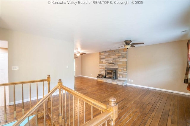102 Utah Hollow Rd, Charleston, WV 25312 - unfurnished living room featuring ceiling fan, hardwood / wood-style flooring, a fireplace, and baseboards