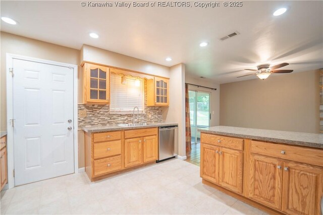 102 Utah Hollow Rd, Charleston, WV 25312 - kitchen featuring stainless steel dishwasher, a sink, decorative backsplash, glass insert cabinets, and ceiling fan