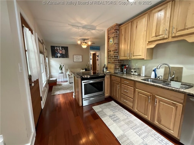 2169 N 21st St, Nitro, WV 25143 - kitchen with stainless steel appliances, a sink, dark wood-style flooring, a peninsula, and stone counters