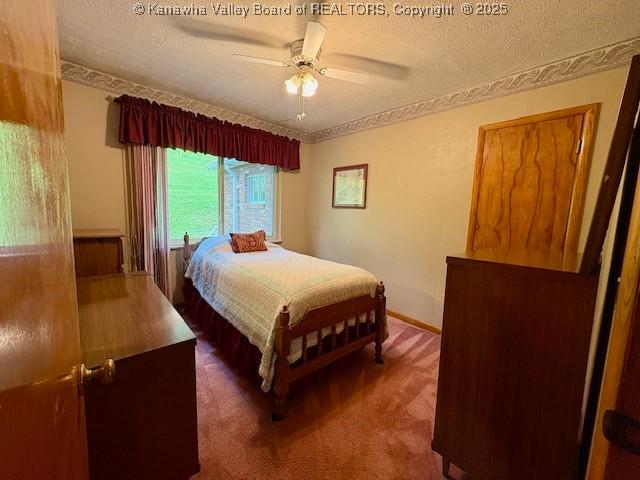 2011 Archibald Dr, Charleston, WV 25320 - carpeted bedroom featuring a textured ceiling and a ceiling fan