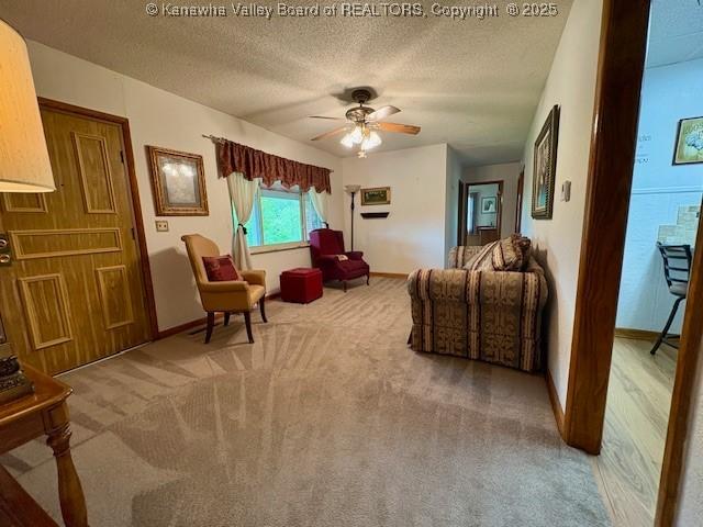 2011 Archibald Dr, Charleston, WV 25320 - carpeted living room with ceiling fan, baseboards, and a textured ceiling