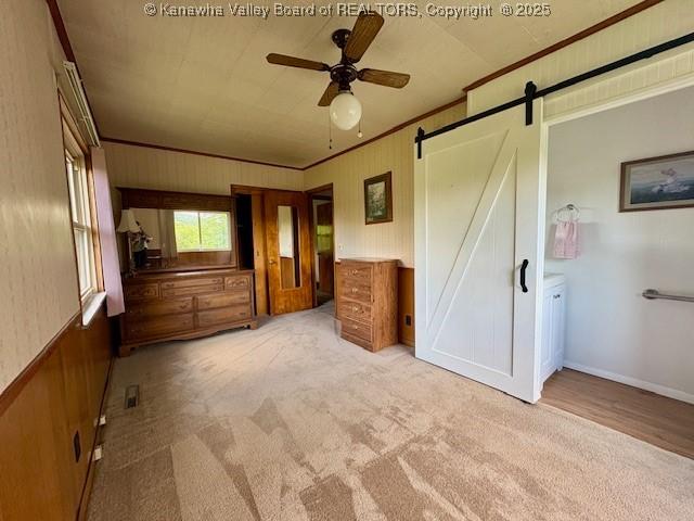 2011 Archibald Dr, Charleston, WV 25320 - unfurnished bedroom with a barn door, crown molding, and carpet