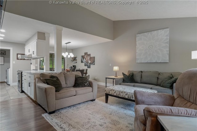 26 Banister Dr, Cross Lanes, WV 25313 - living room featuring a chandelier, baseboards, light wood-style floors, vaulted ceiling, and recessed lighting