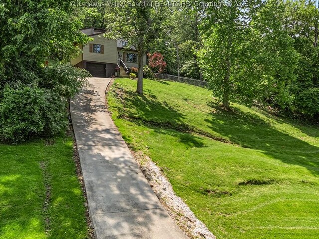 26 Banister Dr, Cross Lanes, WV 25313 - view of front of house featuring a garage, concrete driveway, and stairway