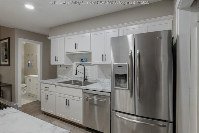 26 Banister Dr, Cross Lanes, WV 25313 - kitchen with appliances with stainless steel finishes, a sink, white cabinets, and light stone countertops