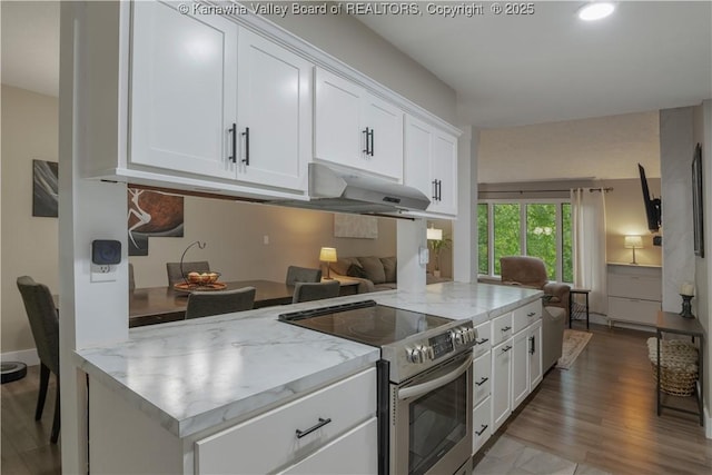 26 Banister Dr, Cross Lanes, WV 25313 - kitchen with stainless steel range with electric stovetop, under cabinet range hood, light stone countertops, and white cabinets