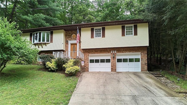 205 Autumn Dr, Dunbar, WV 25064 - bi-level home featuring driveway, an attached garage, brick siding, and a front lawn