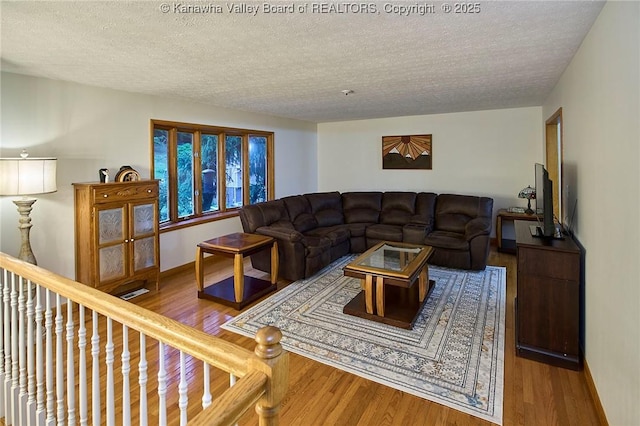 205 Autumn Dr, Dunbar, WV 25064 - living room with a textured ceiling, wood finished floors, and baseboards