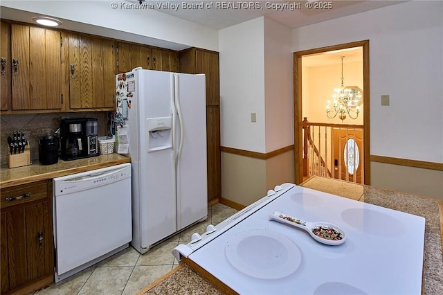 205 Autumn Dr, Dunbar, WV 25064 - kitchen with white appliances, a chandelier, light tile patterned floors, and decorative backsplash