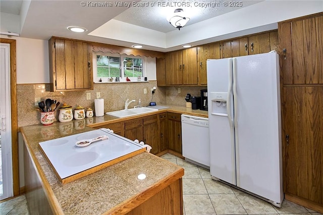205 Autumn Dr, Dunbar, WV 25064 - kitchen with white appliances, a sink, brown cabinetry, backsplash, and light tile patterned flooring