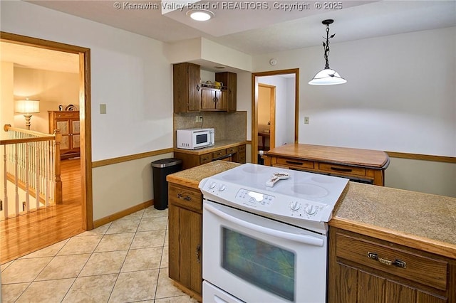 205 Autumn Dr, Dunbar, WV 25064 - kitchen with white appliances, decorative light fixtures, backsplash, light tile patterned floors, and baseboards