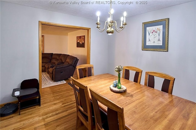 205 Autumn Dr, Dunbar, WV 25064 - dining area featuring a chandelier, wood finished floors, and a textured ceiling