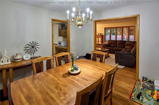205 Autumn Dr, Dunbar, WV 25064 - dining space featuring a chandelier, wood finished floors, and a textured ceiling
