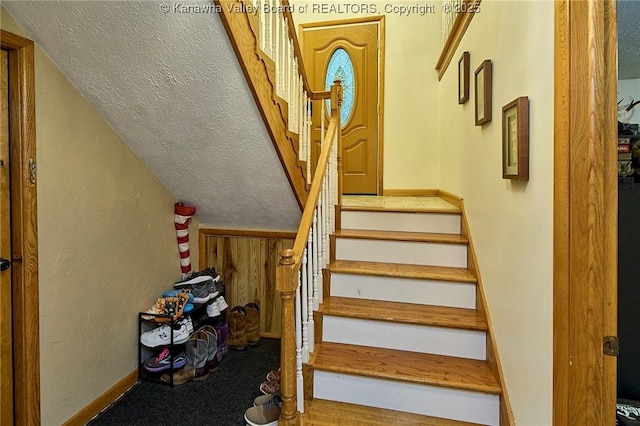 205 Autumn Dr, Dunbar, WV 25064 - staircase with a textured ceiling, carpet floors, baseboards, and lofted ceiling