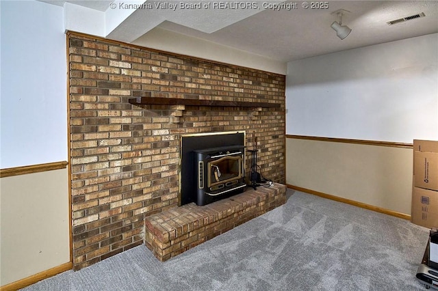205 Autumn Dr, Dunbar, WV 25064 - detailed view of a wood stove, carpet, and baseboards