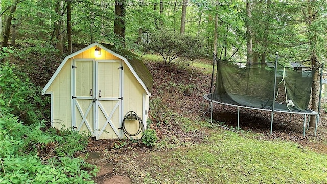 205 Autumn Dr, Dunbar, WV 25064 - view of shed featuring a trampoline and a wooded view