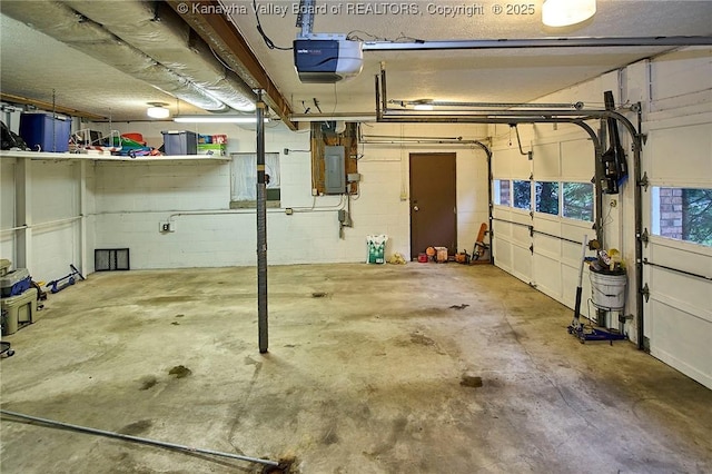 205 Autumn Dr, Dunbar, WV 25064 - garage featuring a garage door opener, electric panel, and concrete block wall