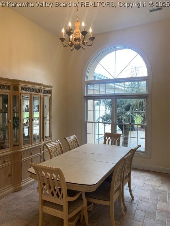 11 Larabee Ln, Winfield, WV 25213 - dining room featuring a chandelier, plenty of natural light, stone tile floors, and baseboards
