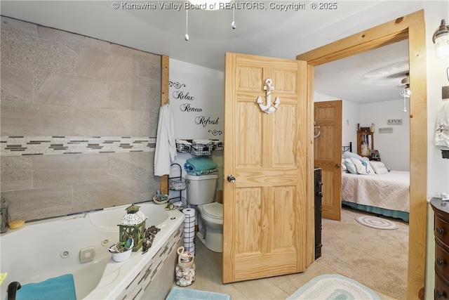 223 Easter Rd, Nitro, WV 25143 - bathroom featuring a whirlpool tub, toilet, and ensuite bath
