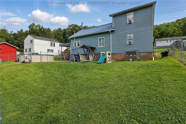 223 Easter Rd, Nitro, WV 25143 - rear view of property with central air condition unit, a playground, and metal roof