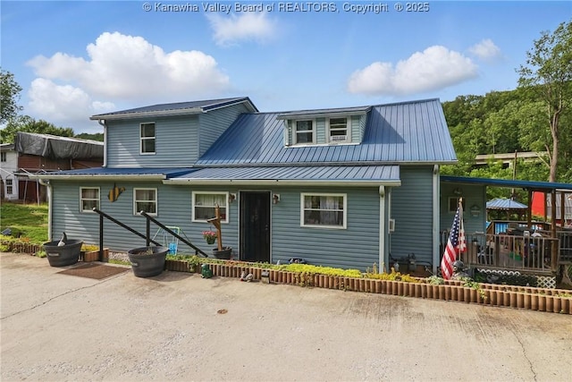 223 Easter Rd, Nitro, WV 25143 - view of front facade with metal roof and a patio