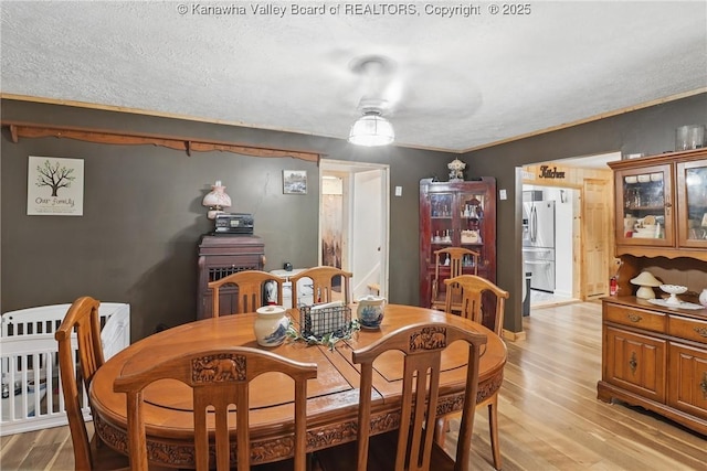 223 Easter Rd, Nitro, WV 25143 - dining room with light wood-style flooring and a textured ceiling