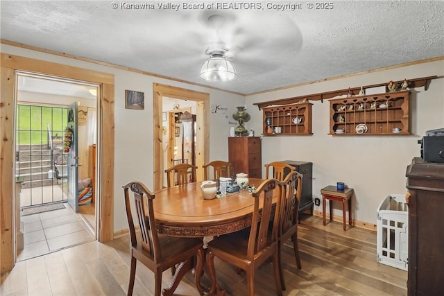 223 Easter Rd, Nitro, WV 25143 - dining room with a textured ceiling, wood finished floors, baseboards, and a ceiling fan