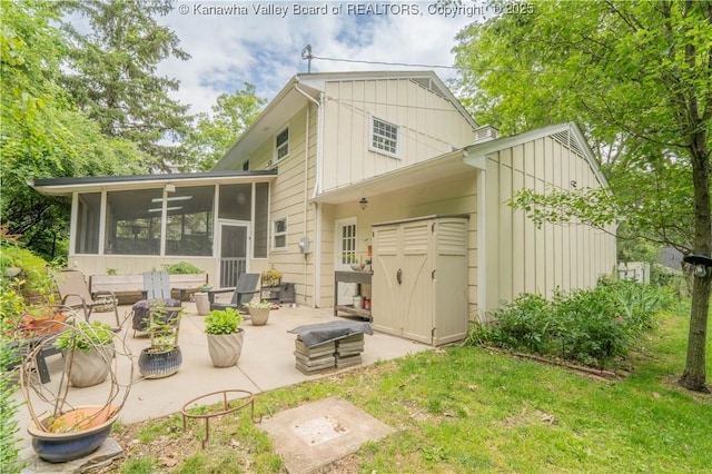 1418 Sweetbrier Rd, Charleston, WV 25314 - rear view of property featuring a patio, board and batten siding, and a sunroom