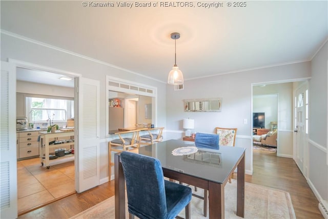 1418 Sweetbrier Rd, Charleston, WV 25314 - dining space with ornamental molding, light wood-style flooring, a desk, and a baseboard radiator