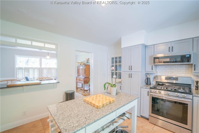 1418 Sweetbrier Rd, Charleston, WV 25314 - kitchen with stainless steel appliances, tasteful backsplash, light tile patterned floors, and light stone countertops