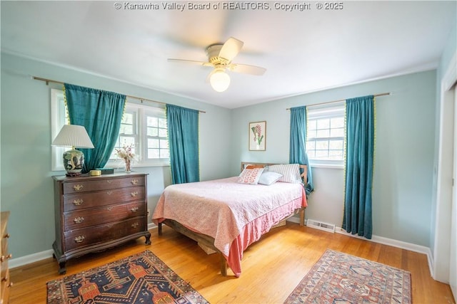 1418 Sweetbrier Rd, Charleston, WV 25314 - bedroom featuring multiple windows, wood finished floors, baseboards, and a ceiling fan