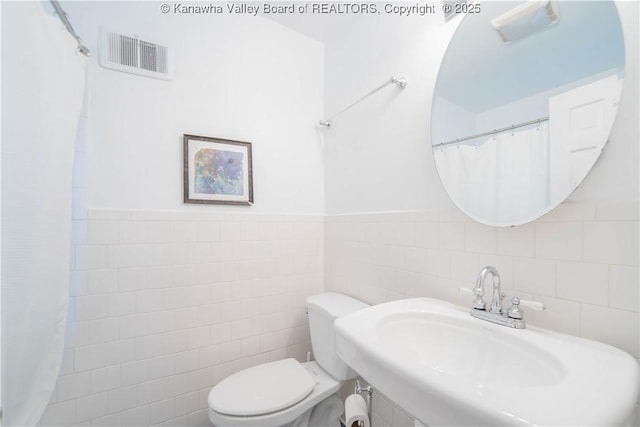 1418 Sweetbrier Rd, Charleston, WV 25314 - full bathroom with tile walls, toilet, and a sink