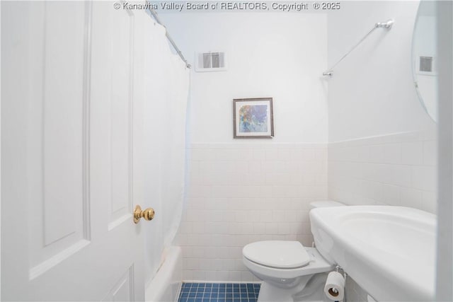 1418 Sweetbrier Rd, Charleston, WV 25314 - bathroom with toilet, tile walls, tile patterned floors, a sink, and shower / tub combo