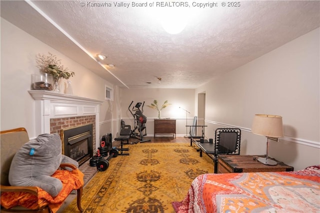 1418 Sweetbrier Rd, Charleston, WV 25314 - bedroom with a textured ceiling and a brick fireplace