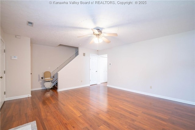 911 4th Ave, Saint Albans, WV 25177 - unfurnished living room with stairs, ceiling fan, wood finished floors, and baseboards