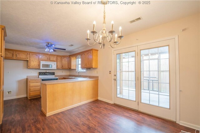 911 4th Ave, Saint Albans, WV 25177 - kitchen with white microwave, range with electric cooktop, a sink, a peninsula, and a chandelier