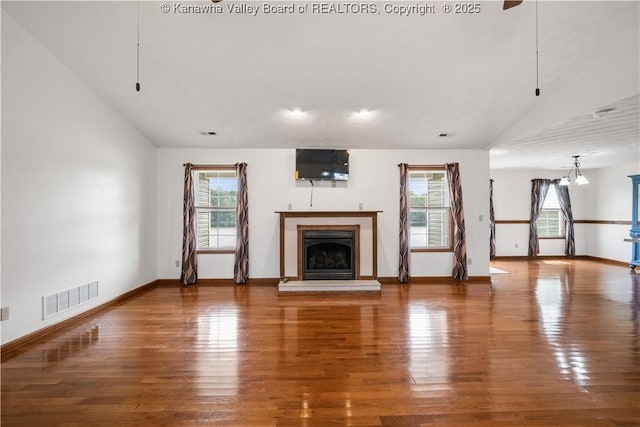 213 Rumer Sta, Red House, WV 25168 - unfurnished living room featuring baseboards, a fireplace with raised hearth, wood finished floors, and lofted ceiling