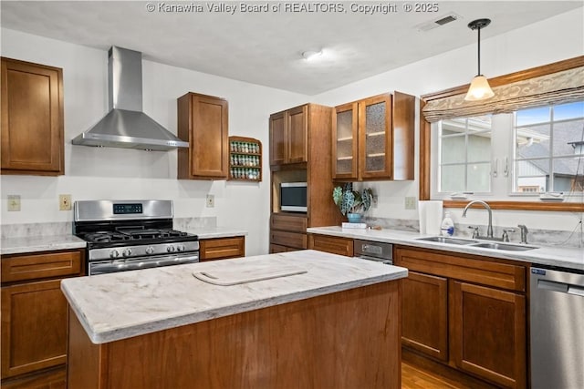 213 Rumer Sta, Red House, WV 25168 - kitchen with wall chimney exhaust hood, stainless steel appliances, a sink, a kitchen island, and decorative light fixtures